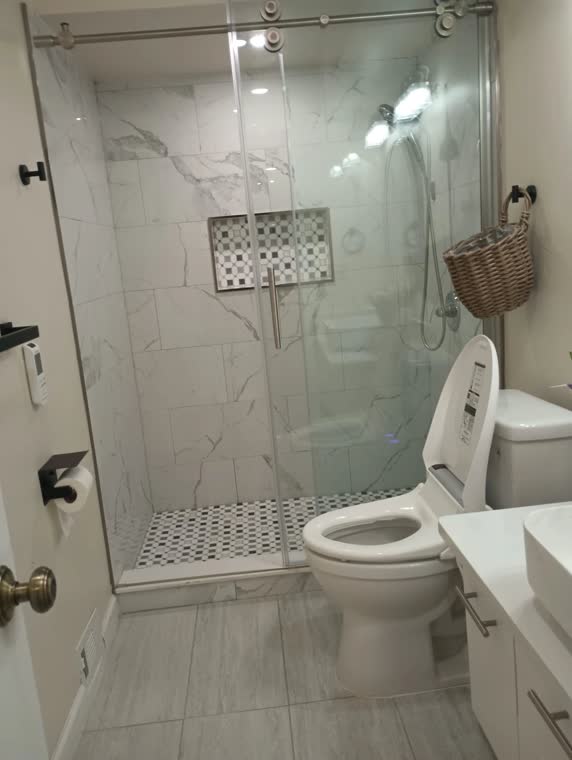 Bathroom with a marble walk-in shower.